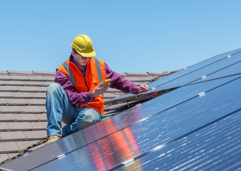 worker and solar panels