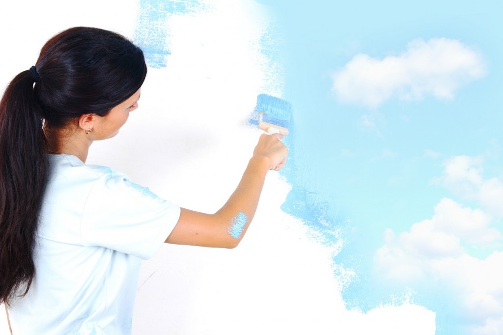 10548050 - woman paints the wall brush