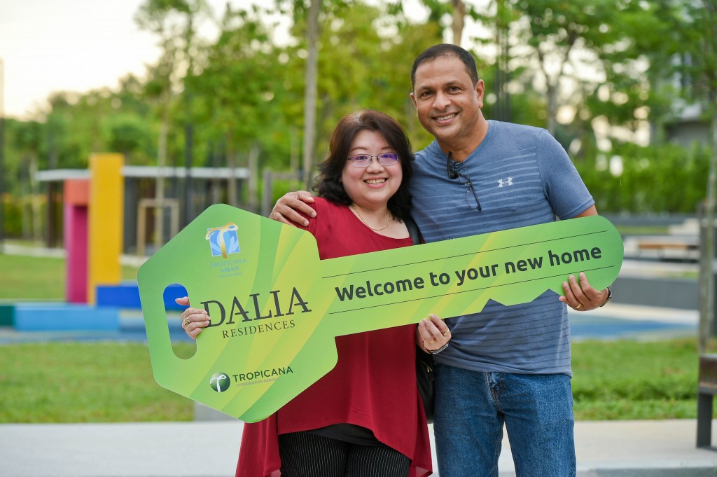 Owners Sugunan Nair and Lin receive a mock key of their unit at Tropicana Aman.