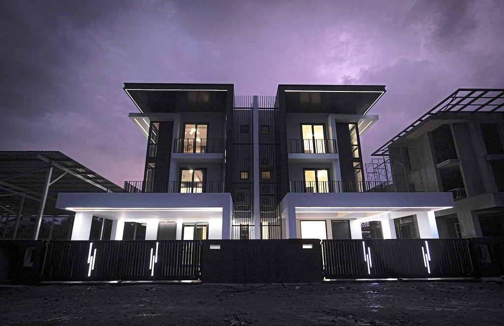 An evening view of a completed semi-detached with the impressive lighting features.