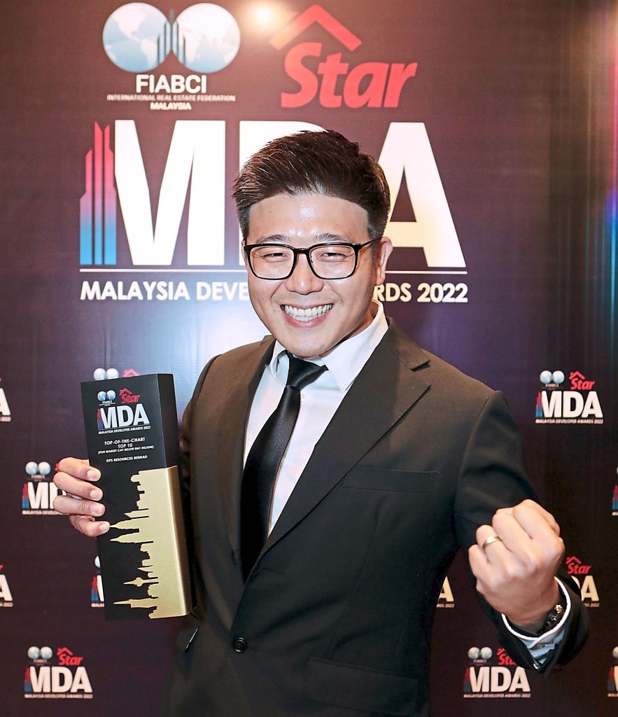 DPS Resources managing director Edward Sow is all smiles when posing with his trophy at the photo booth.