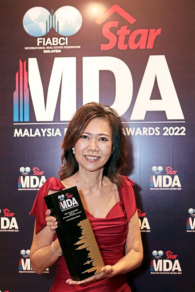 AYER Holdings chief operating officer Jeannie Khoo happily showing the MDA trophy.