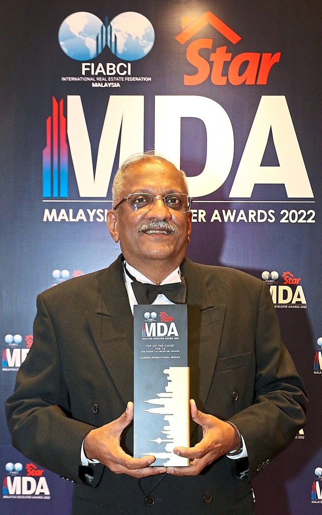 Jiankun International chief executive office and executive director Edwin Silvester Das proudly takes a photo with his MDA trophy.