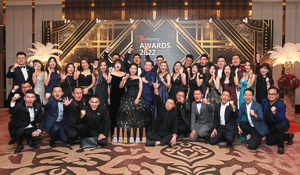 The Roof Realty members are pleased with their trophies.