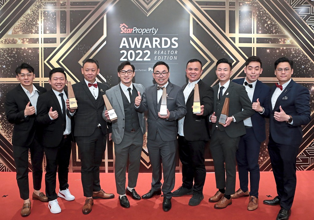 The Global Link Plus Properties team hold up their trophies.