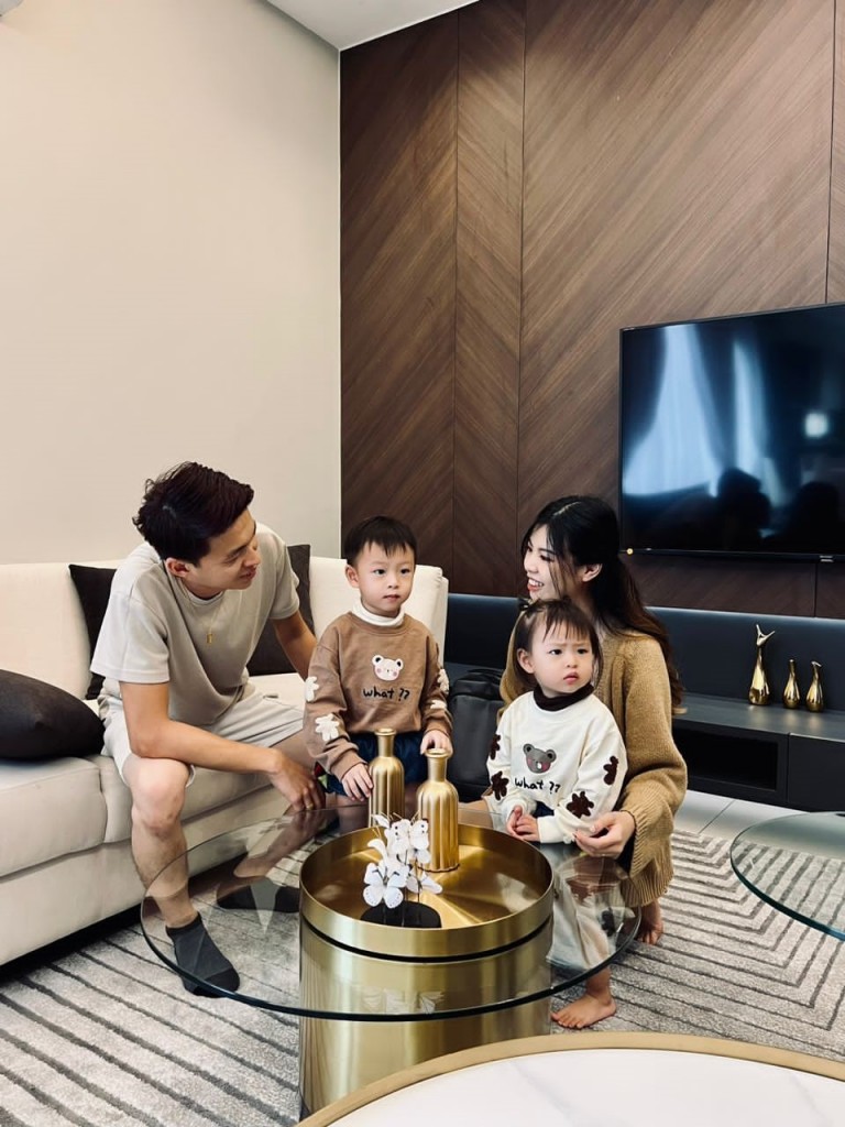 Yew (right) with her family enjoying their home.