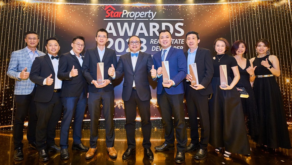 A celebratory photo of the SkyWorld team and the trophies they won.