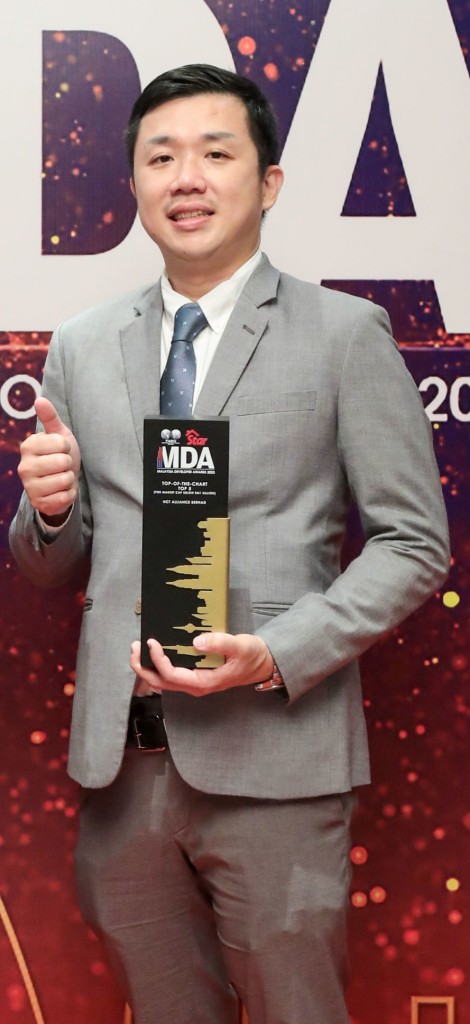 NCT Alliance executive director Yap Chun Theng gestures a thumbs up after receiving his trophy.