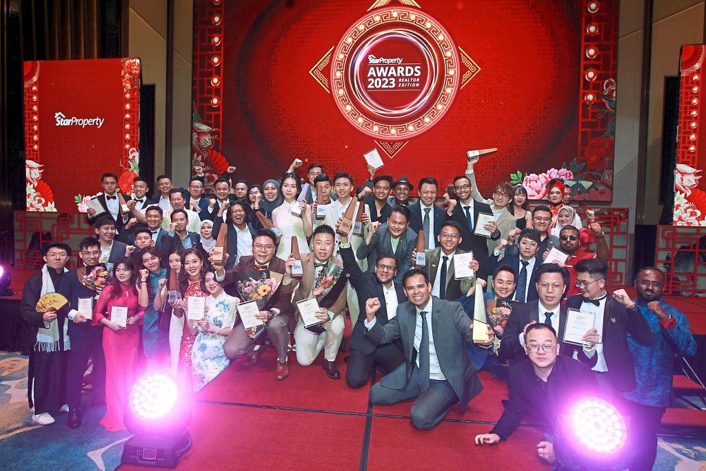 The IQI Realty team members celebrate their big haul of trophies.