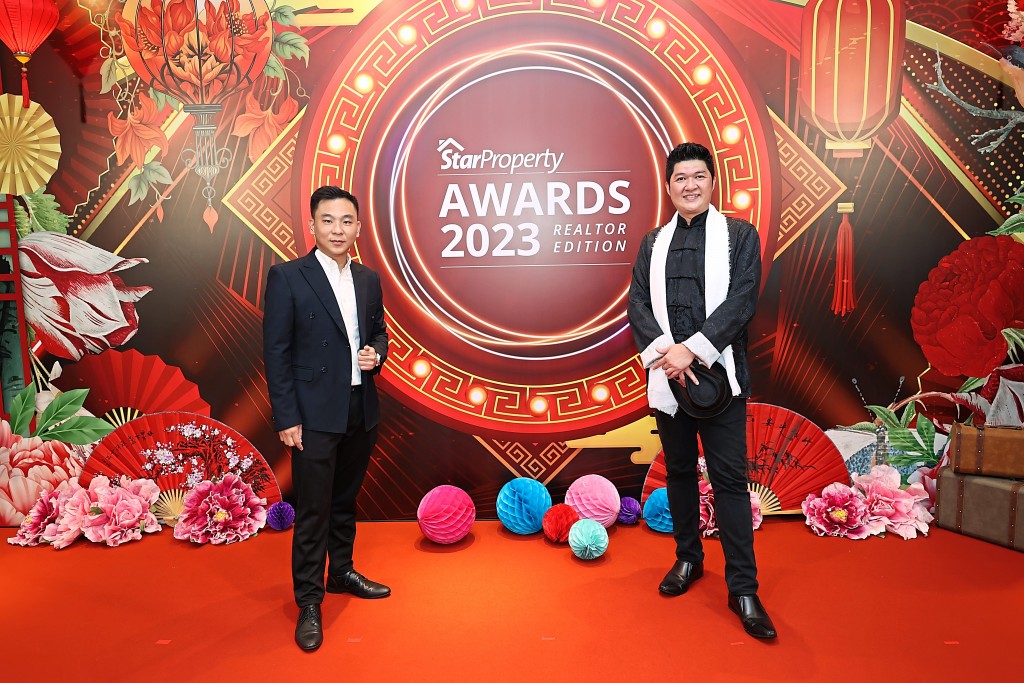 Sky Lim (left) and Joel Tee from Knight World Realty show the contrast of modern and traditional attire.