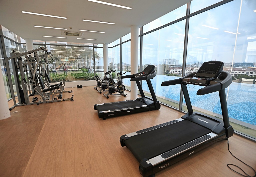 The gym looks out to the infinity pool and the uninterrupted city view.