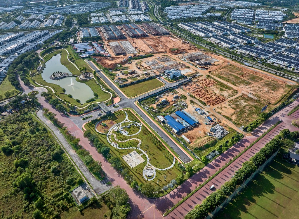 An aerial view of the site with a lake park and playground fronting the gated exclusive enclave.