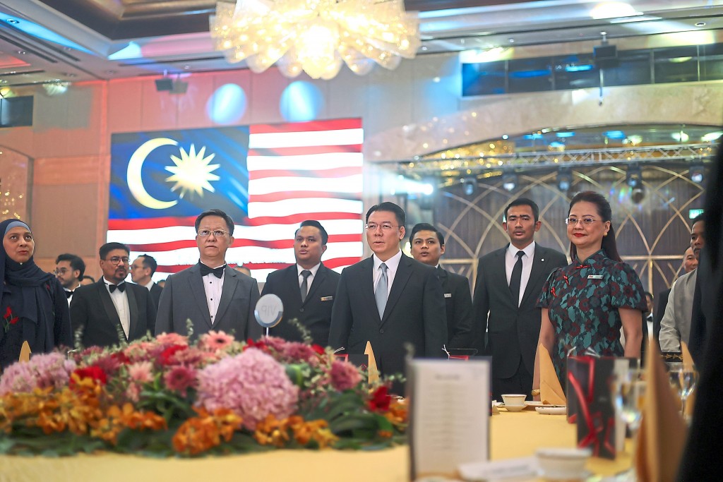 Together, everyone stands for the National Anthem.