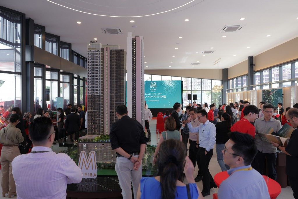 Guests viewing the scale model at the gallery.