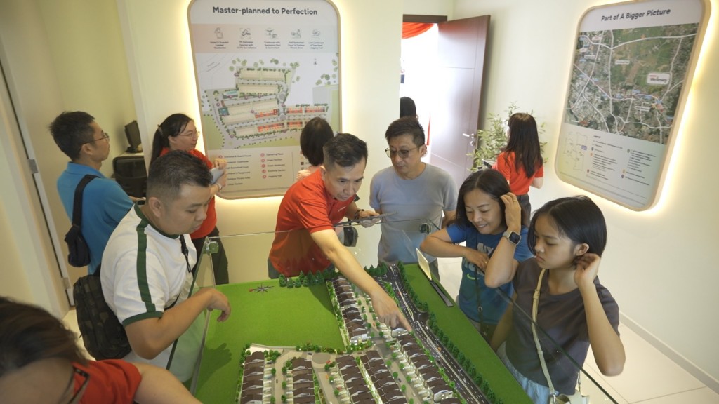 Home buyers eyeing the units displayed at the scale model.