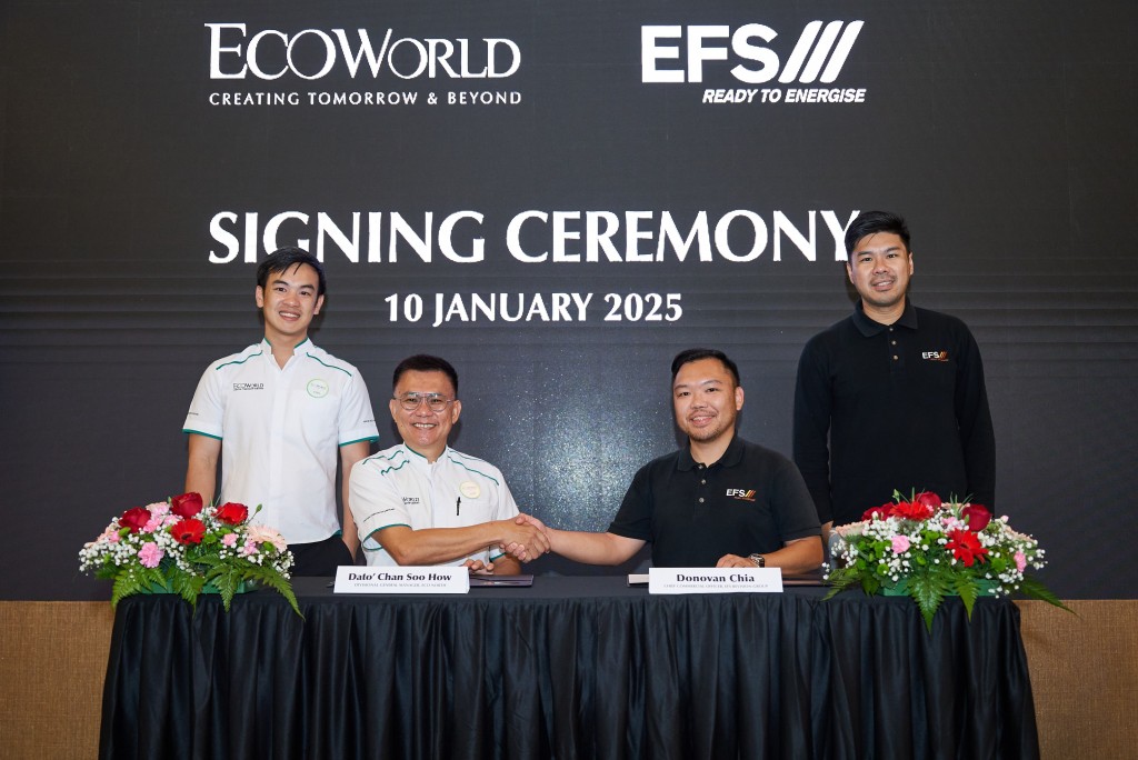  (Seated, left) Chan and Chia shake hands at the agreement signing while Liew (standing, left) and Tan (standing, right) look on.