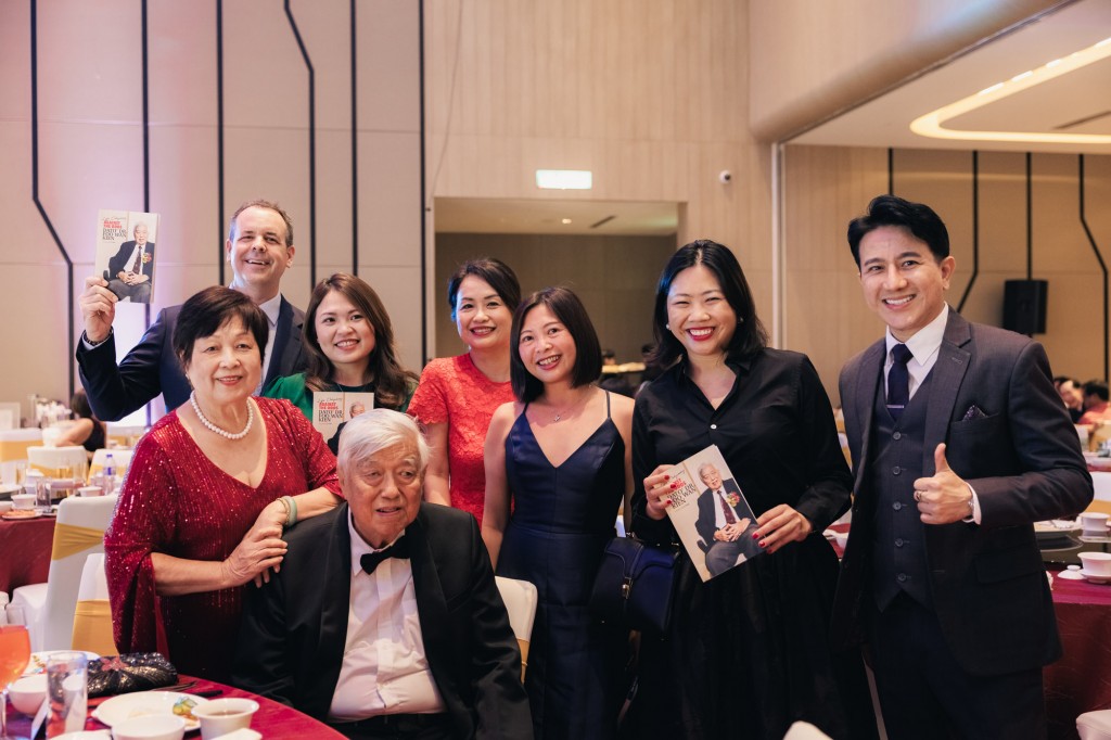 Foo (seated) with family, friends and corporate partners celebrating the unveiling of his biography. 