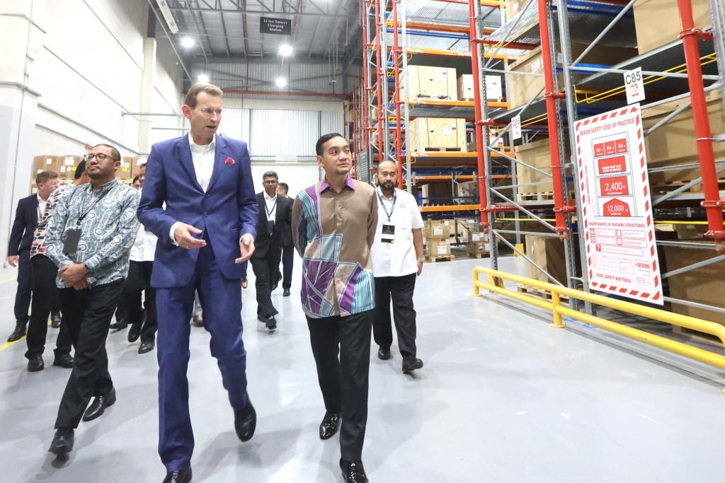 Mercedes-Benz global parts logistic operations head Klaus Ziemsky (left in blue suit) with Onn Hafiz (right) touring the Mercedes-Benz regional logistics centre at Senai Airport City in Kulai, Johor. — THOMAS YONG/The Star
