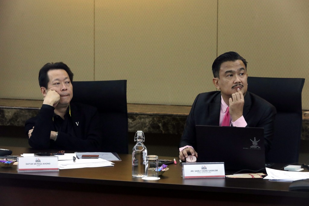 Pondering what questions to ask are Khong (left) and Sarly when listening to one of the presentations for the Rising Star category.